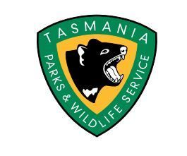 Tasmania Parks & Wildlife Service logo: green shield with snarling Tasmanian devil on a yellow background.