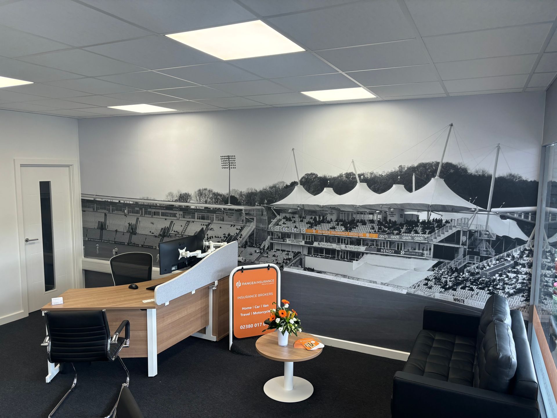 Photo of black and white wallpaper of the Utilita Bowl in the Pangea Insurance Brokers Private Clients office in Chandlers Ford