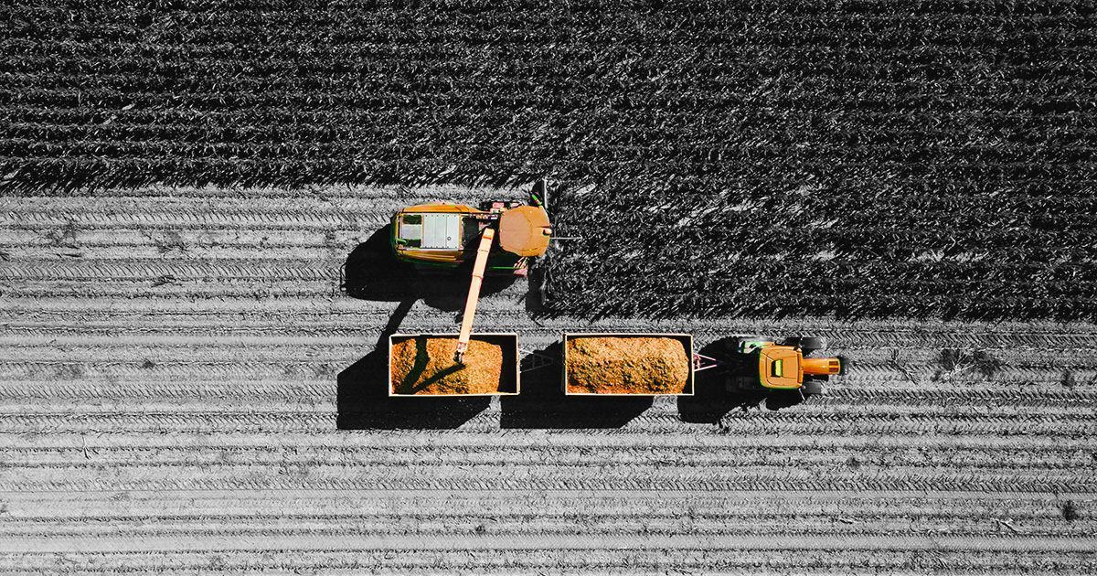 Black and white image overhead looking at combine harvesters to represent agriculture insurance