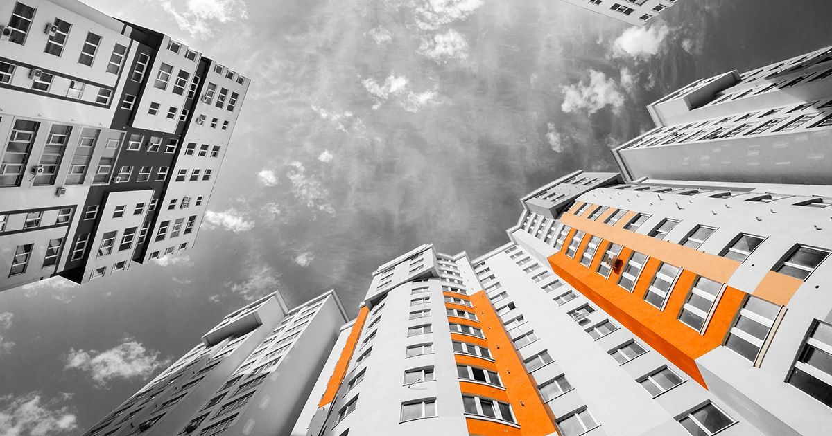 Black and white image of buildings with orange paint