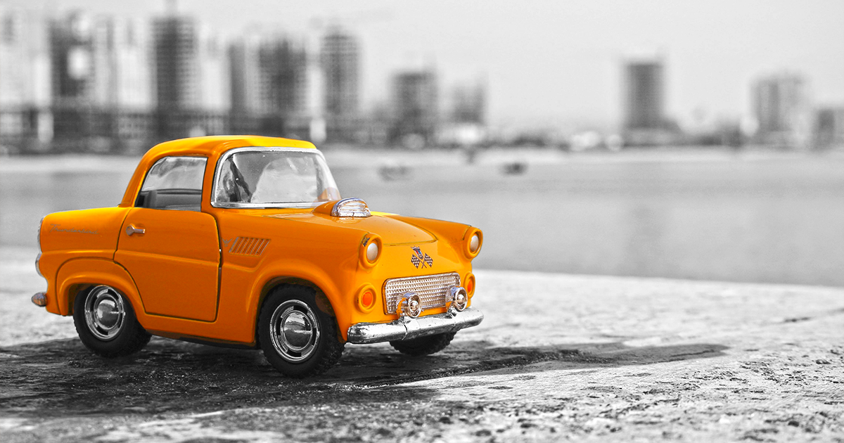 Orange vintage car in black and white image