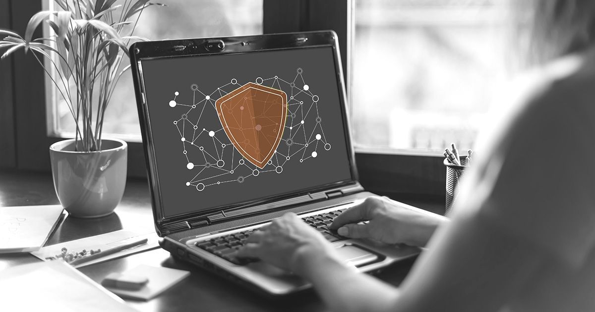 Black and white image showing laptop with cyber icons representing cyber security