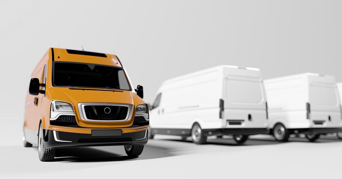 Black and white image with orange van and fleet vehicles in background