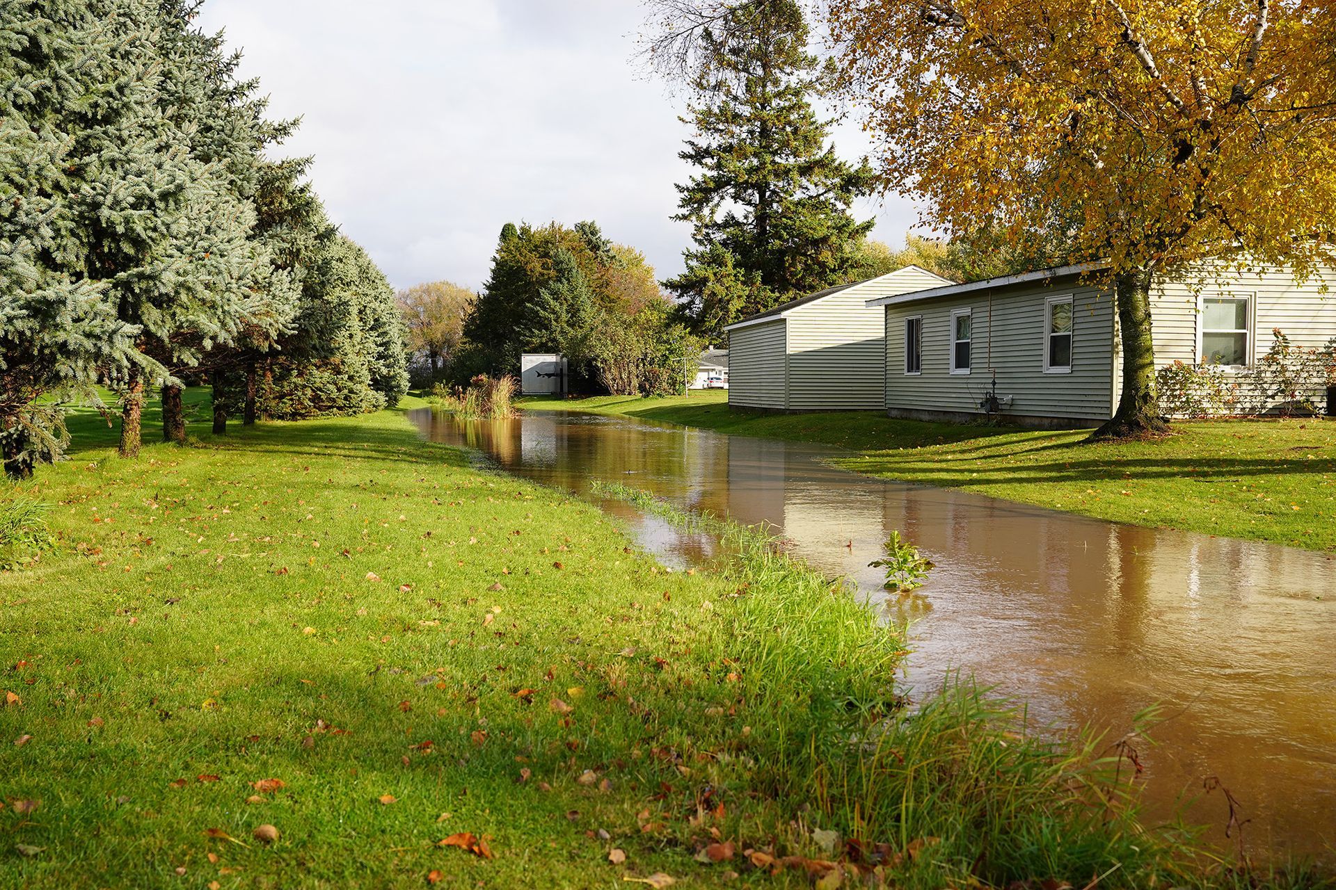 Flooded area with homes in background