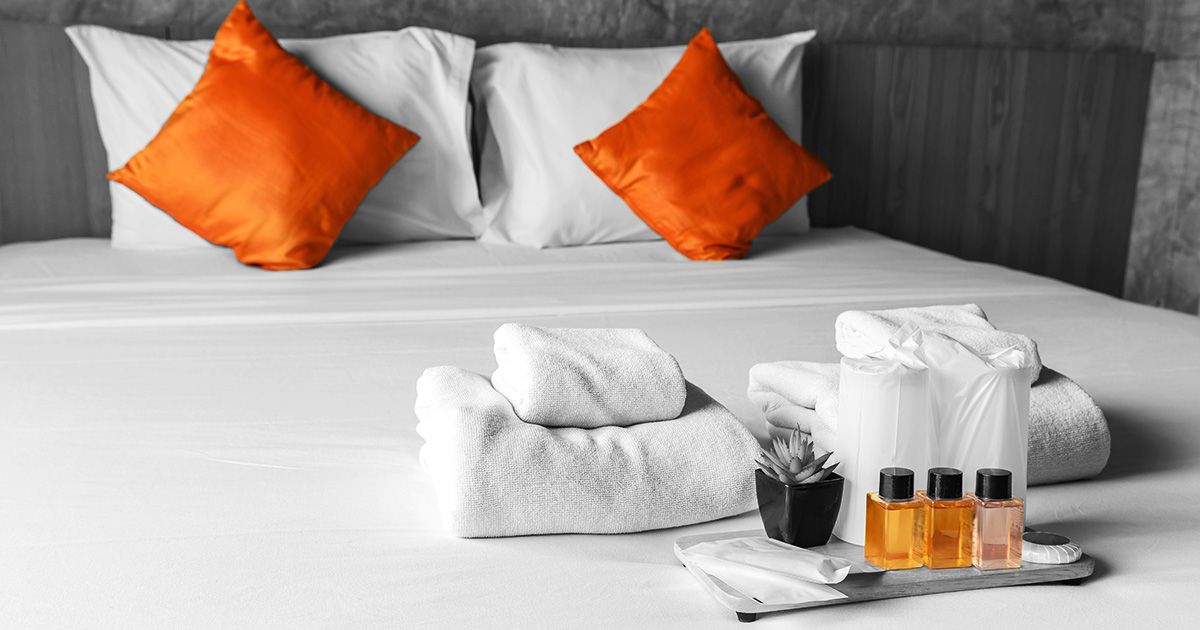 Black and white image of bed in hotel to represent hospitality insurance