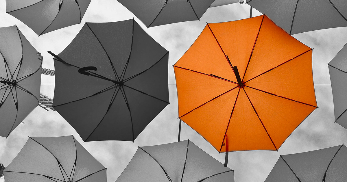 Black and white image with orange umbrella to represent general insurance