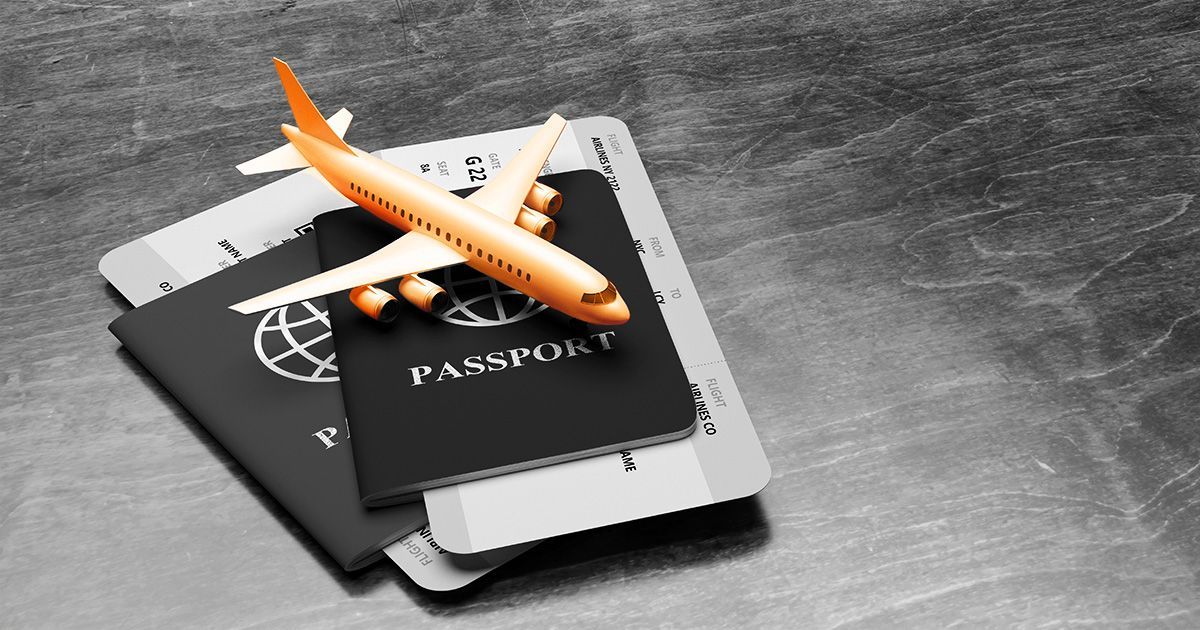 Orange toy plane on passport to represent travel insurance