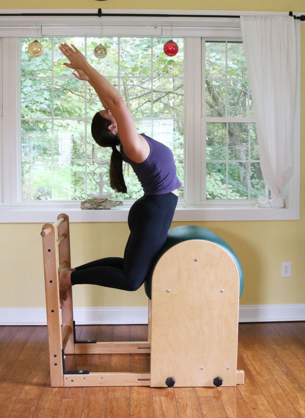 a woman is doing exercises on a pilates machine