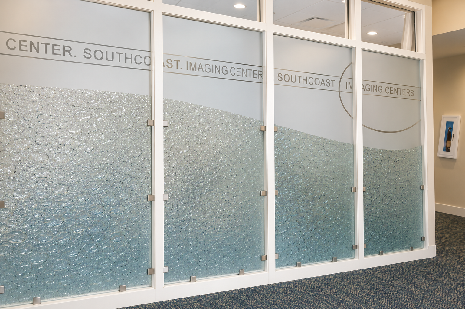 Frosted glass office doors with white frames in a carpeted hallway