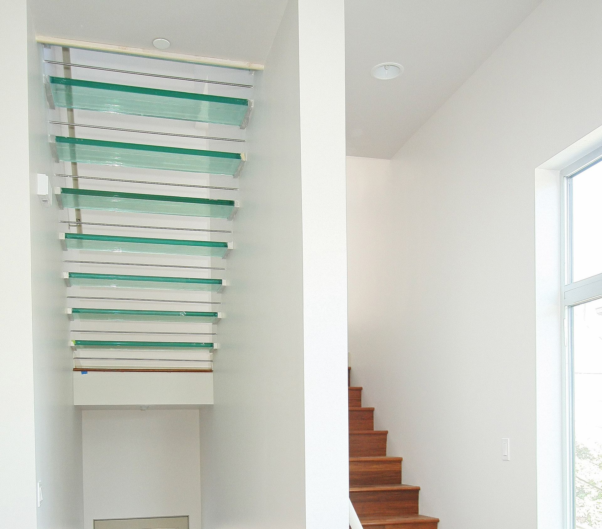 White interior with a glass tread staircase.