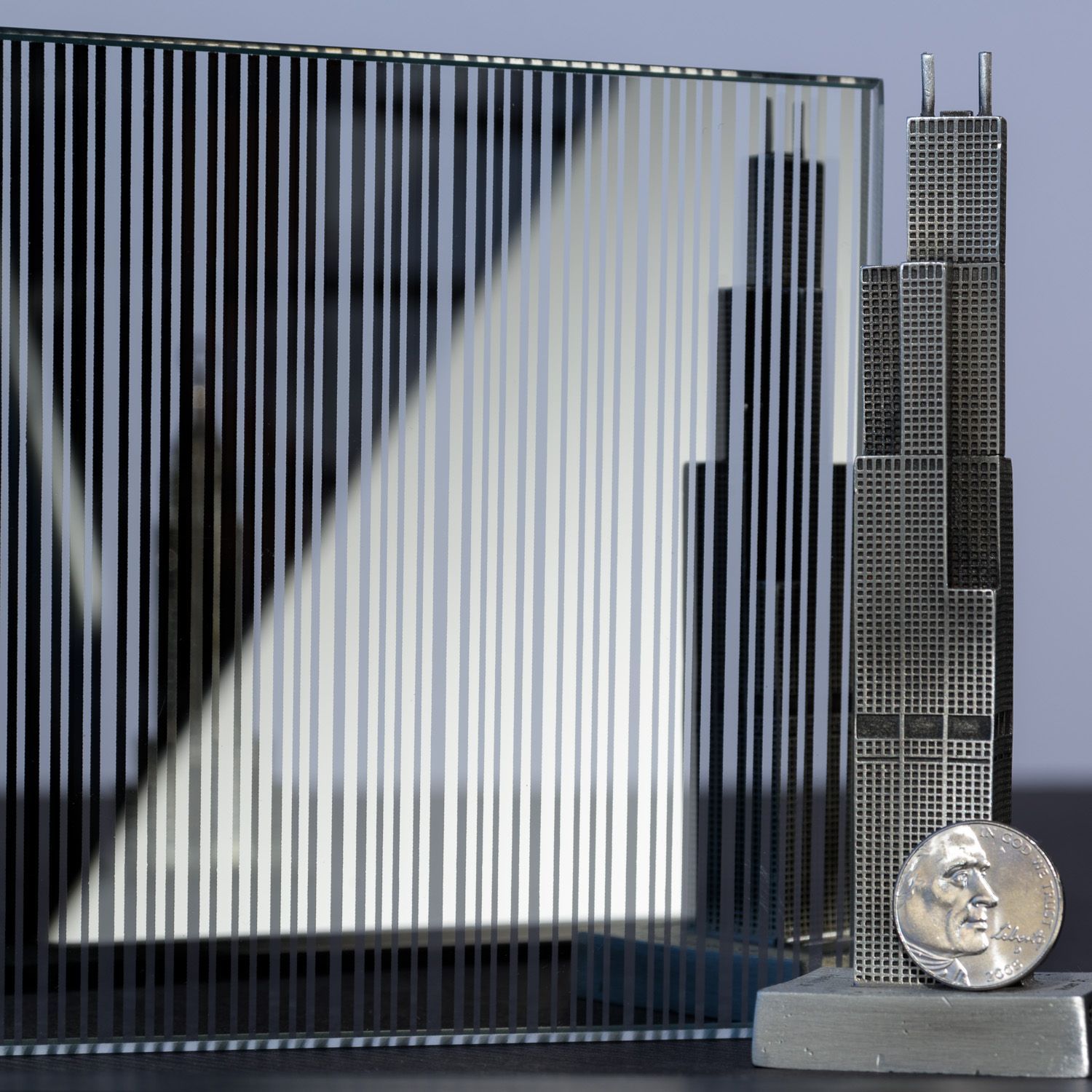 Miniature Willis Tower and a patterned glass panel with a nickel.