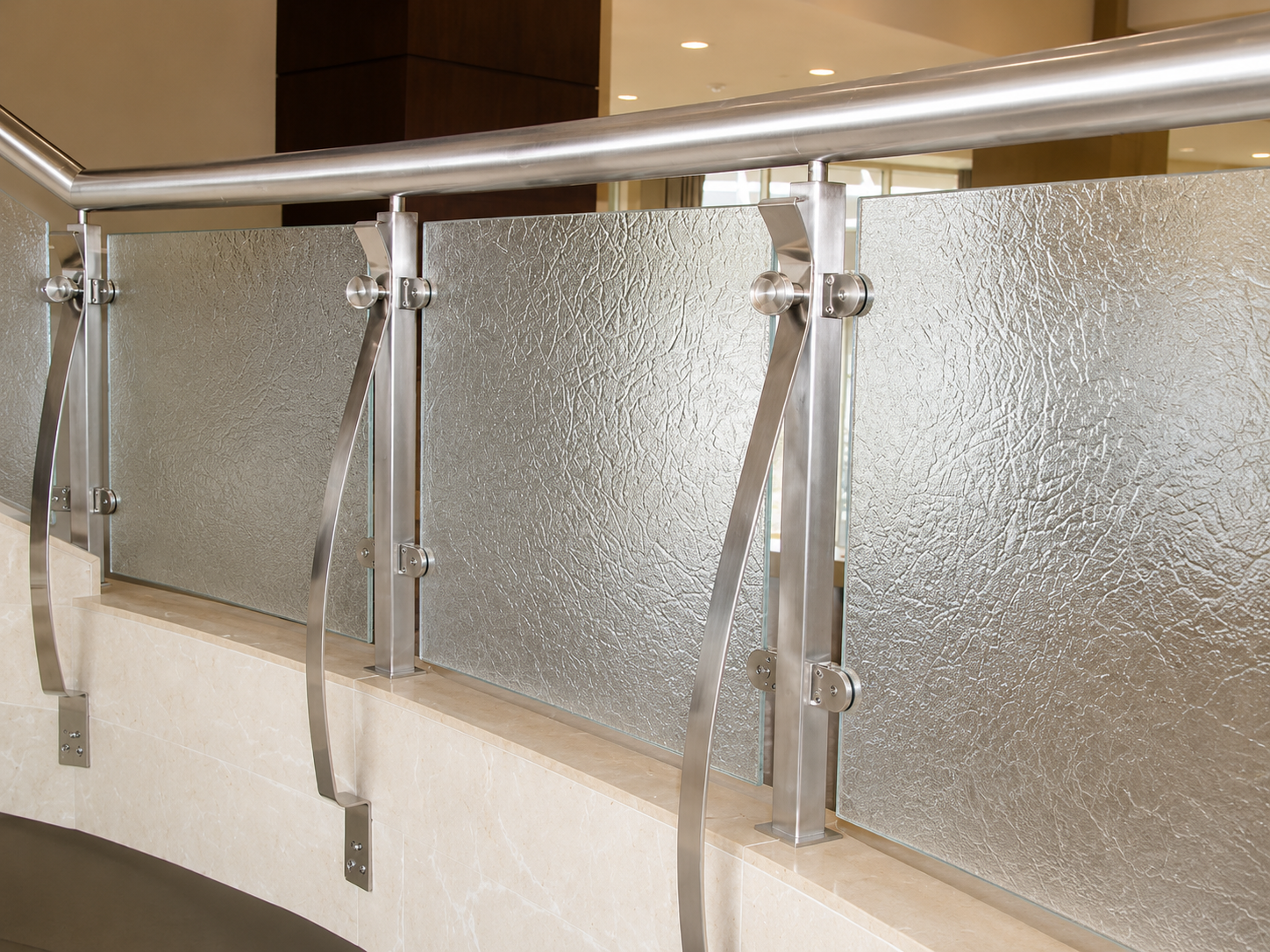 Metal and frosted glass stair railing in an indoor hallway