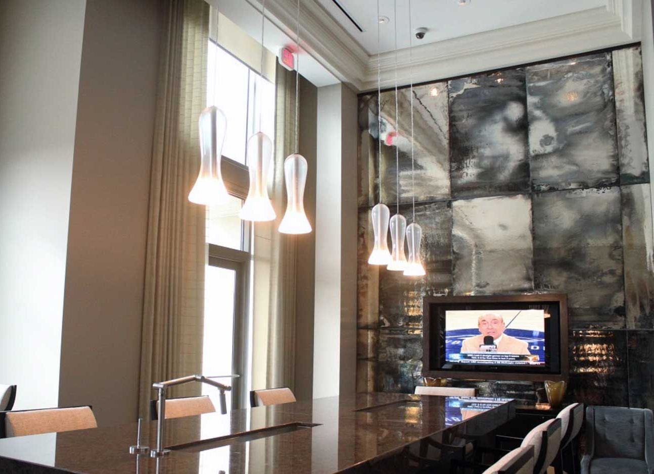 A living room with a large mirrored wall and a flat screen tv