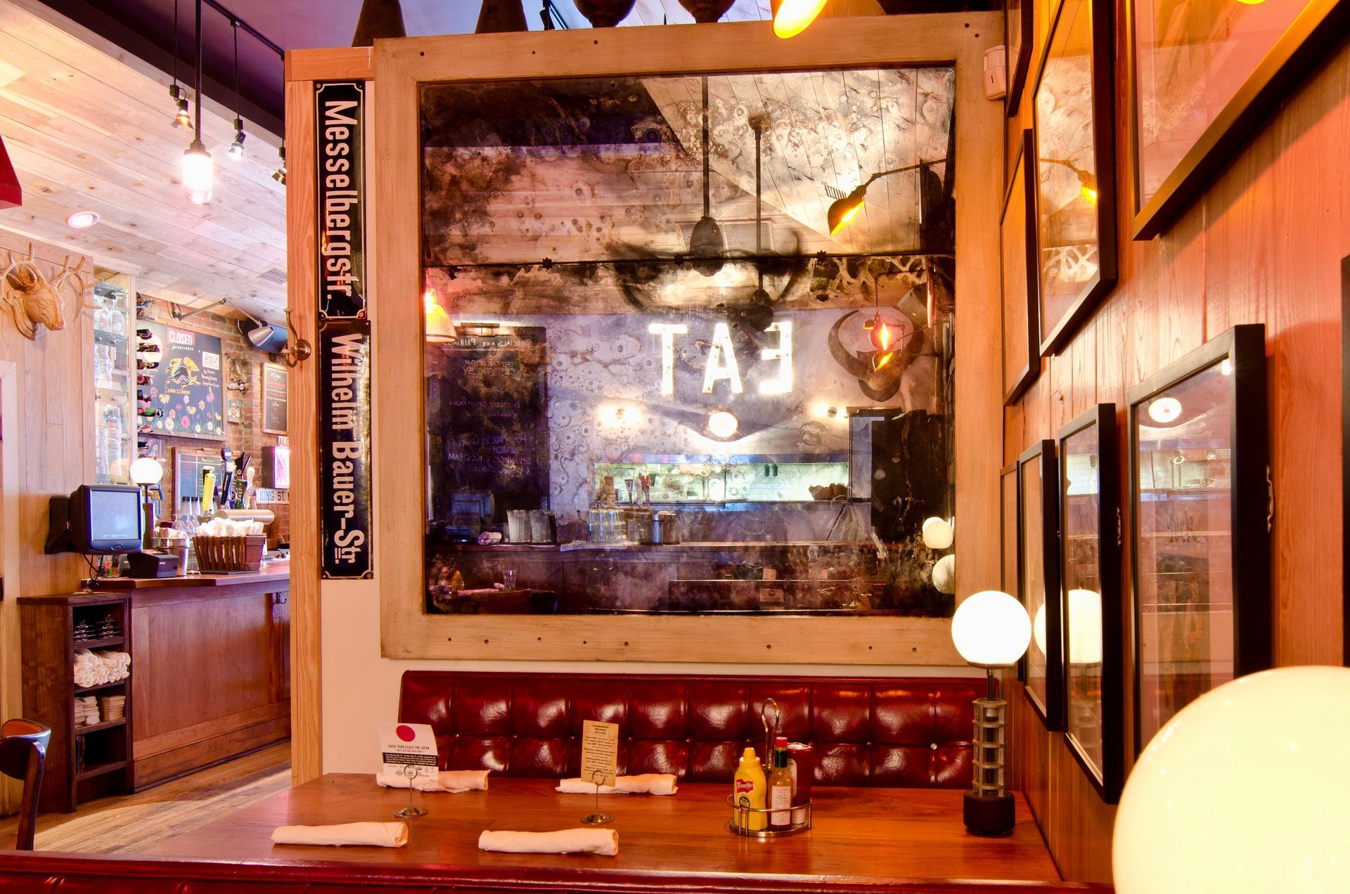 A restaurant with an antique mirror sign