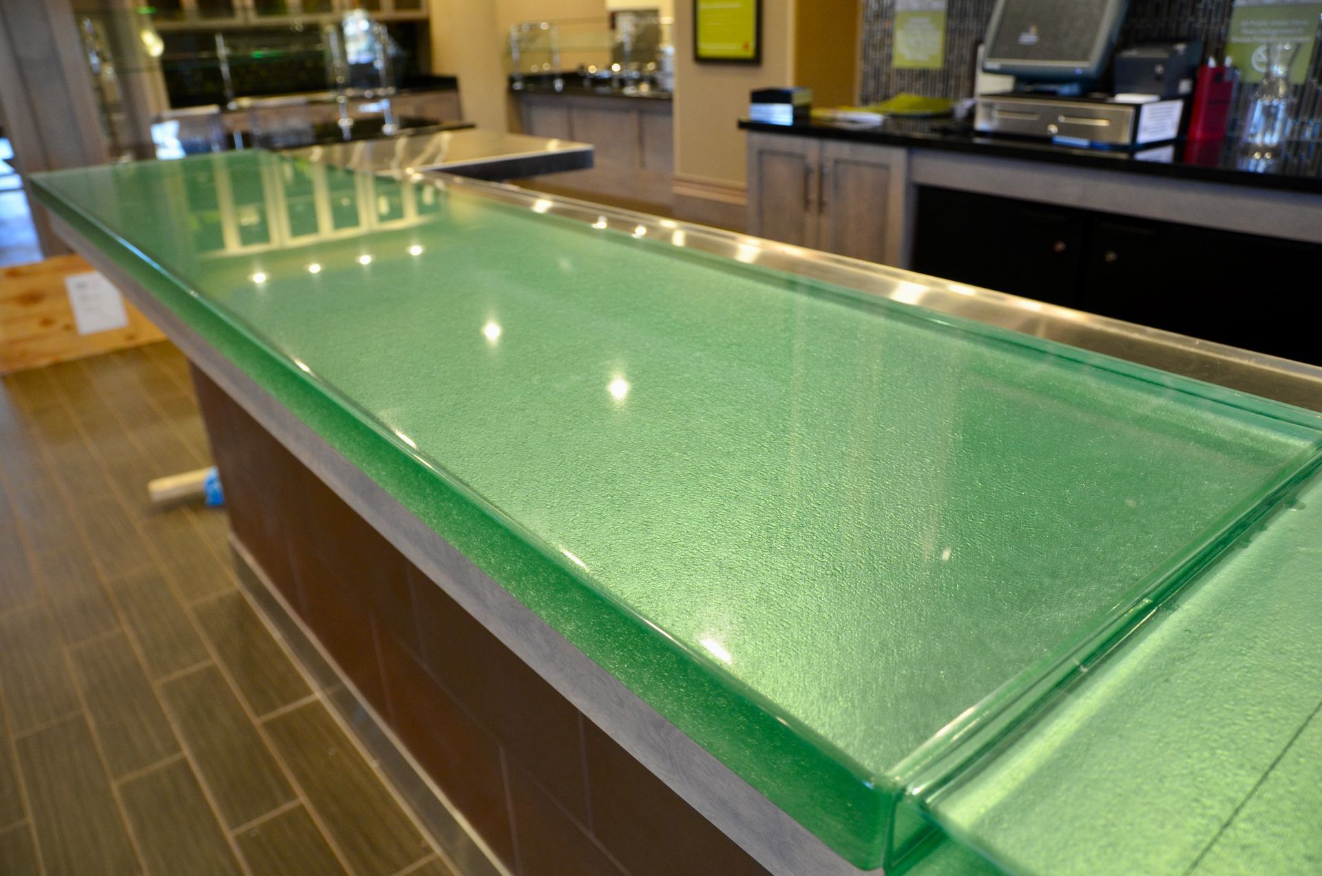 A green glass counter top in a kitchen.