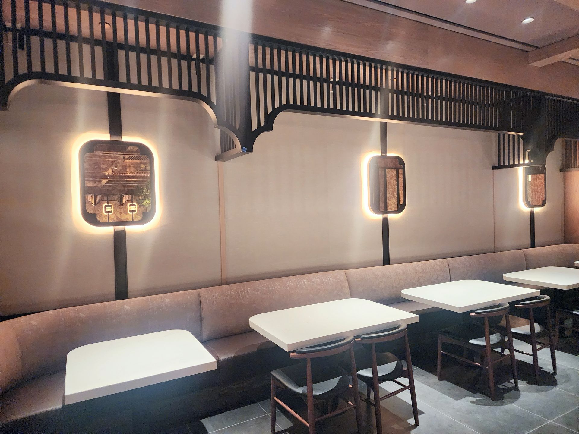 Interior of a restaurant with booths and tables. Antique mirror inserts.