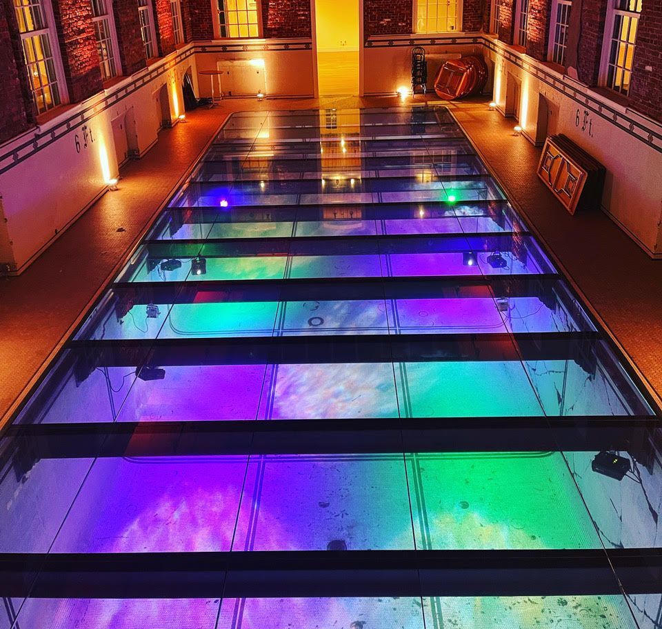 A glass floor with colorful lights under it