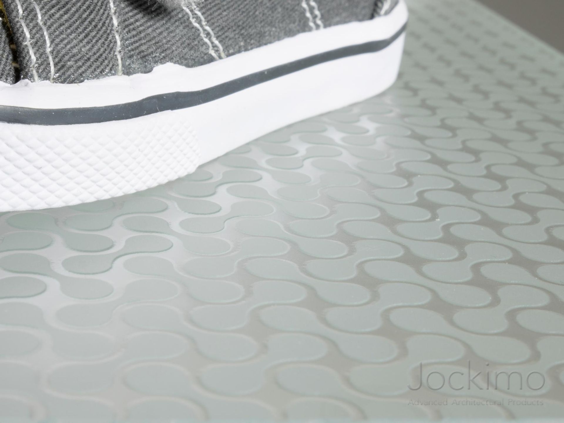 A shot from below of people walking on anti-slip glass flooring.