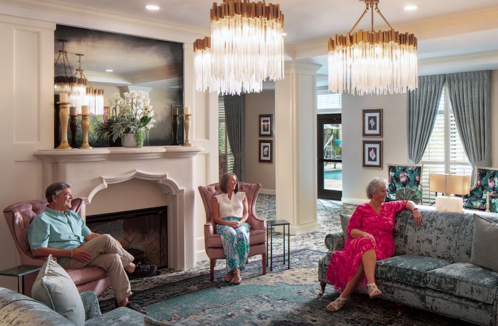 A man and a woman are sitting on a couch in a living room.