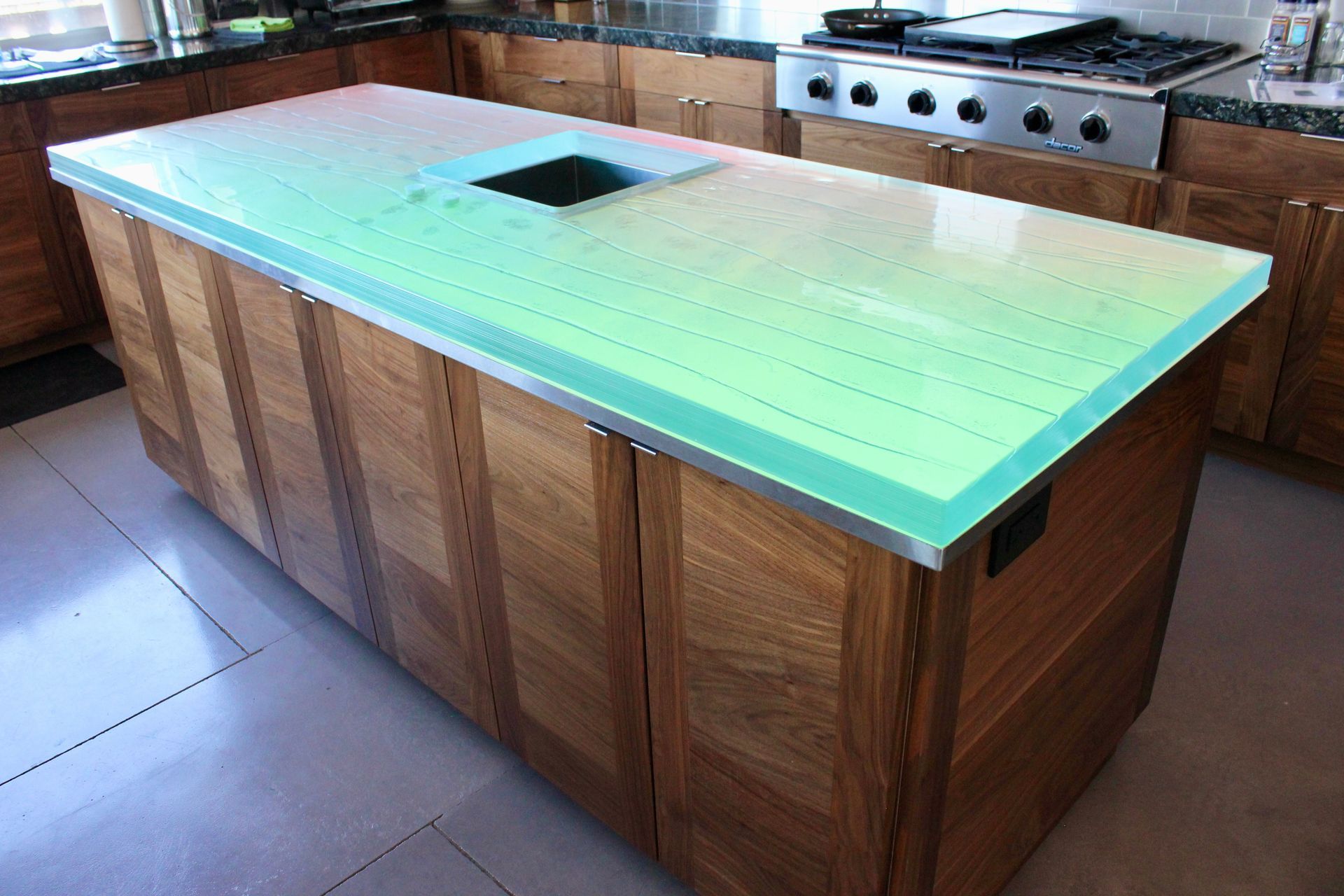 A kitchen with a glass top large island