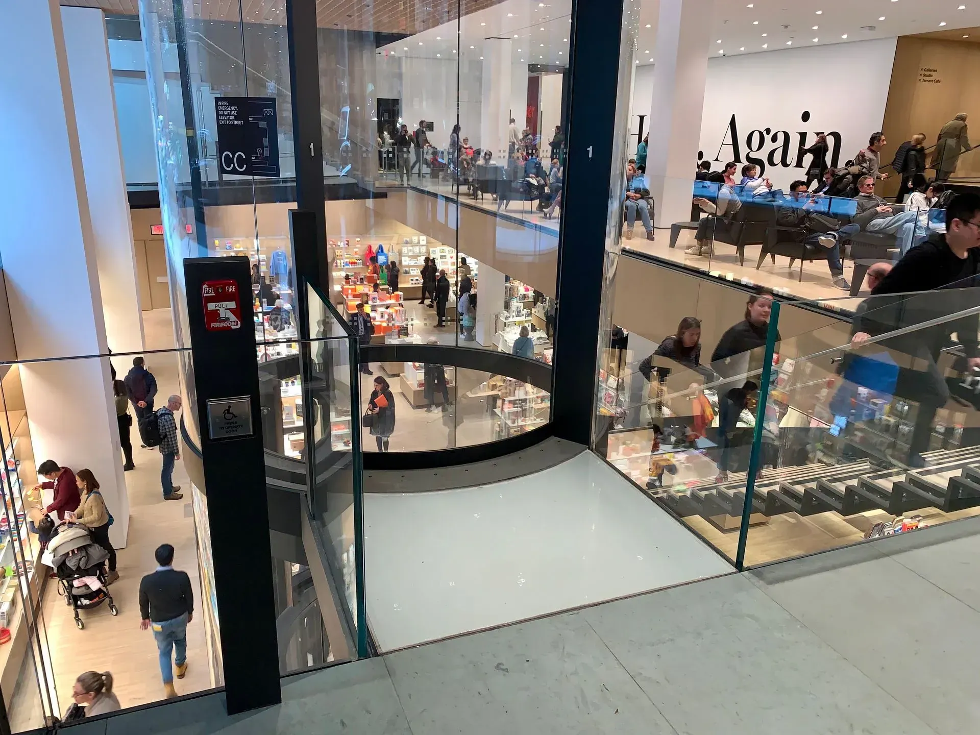 A group of people are standing in a large building.