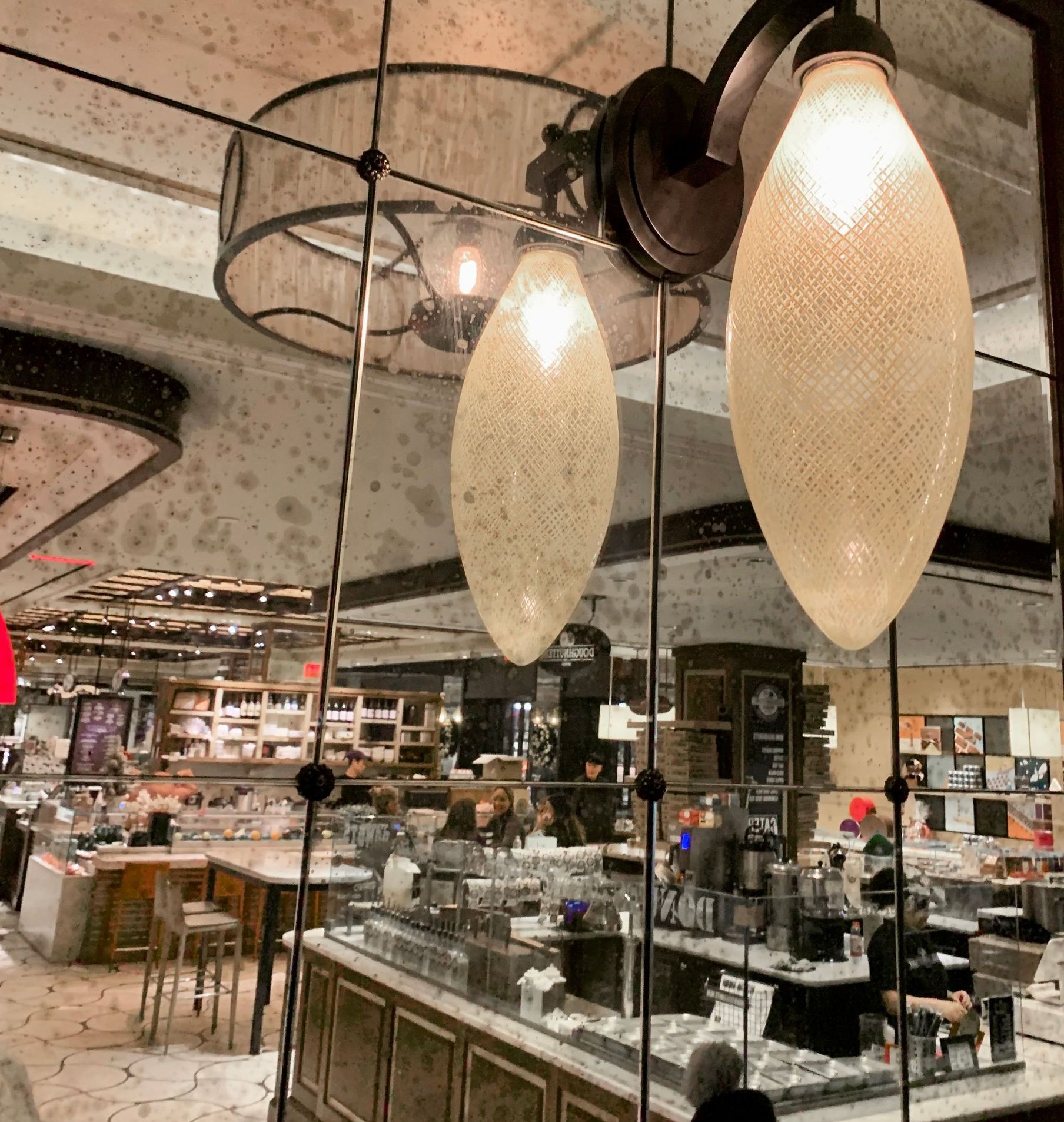 A restaurant with a lot of lights hanging from the ceiling