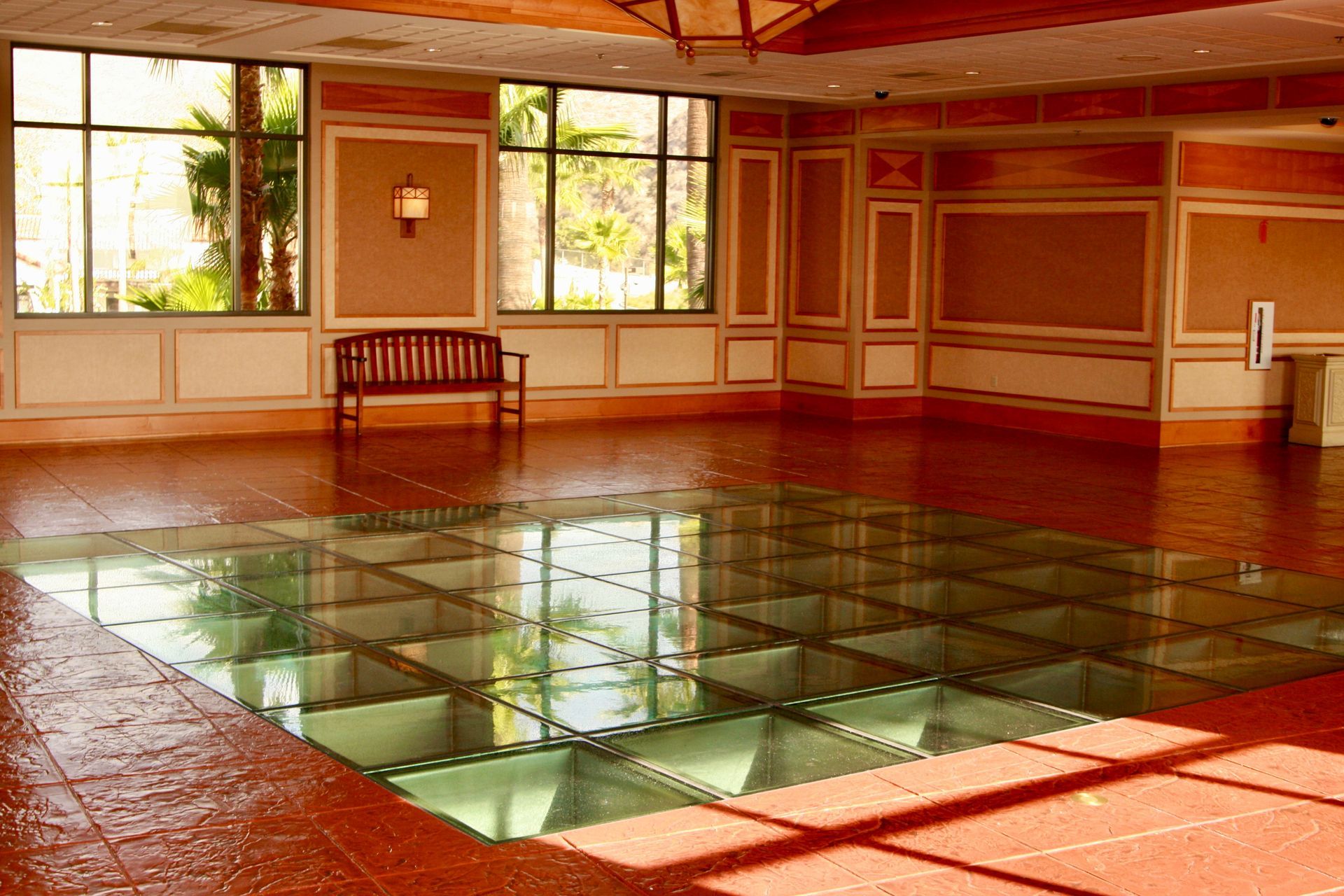 Glass flooring incorporated into tile flooring.
