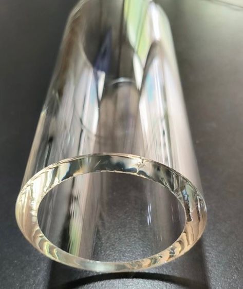 A clear glass tube with a hole in the middle