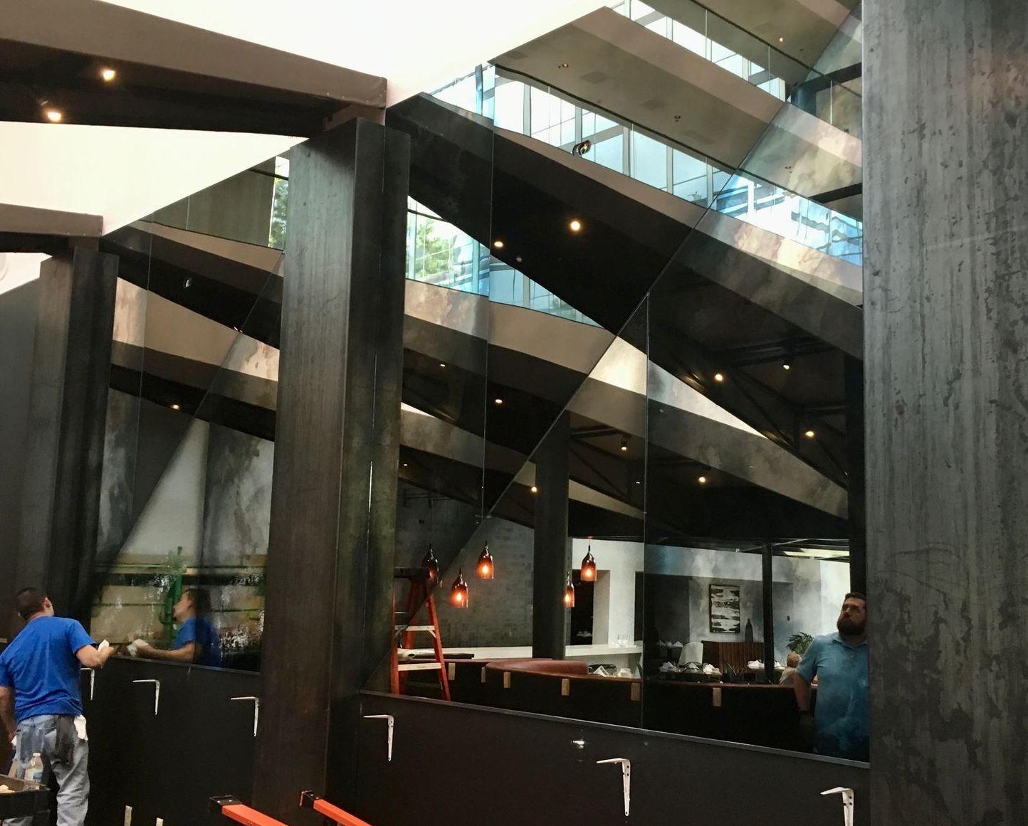 A group of people are standing in a room with a number 7 on the wall