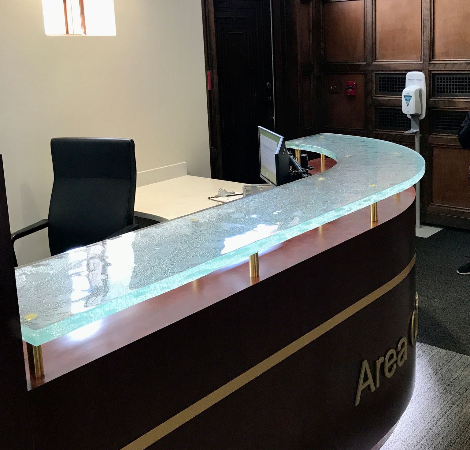 A reception desk with a glass countertop