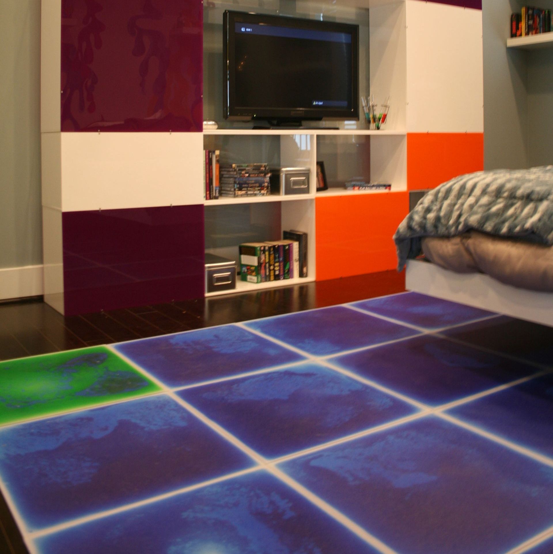 purple and green liquid lava floor tiles in bedroom