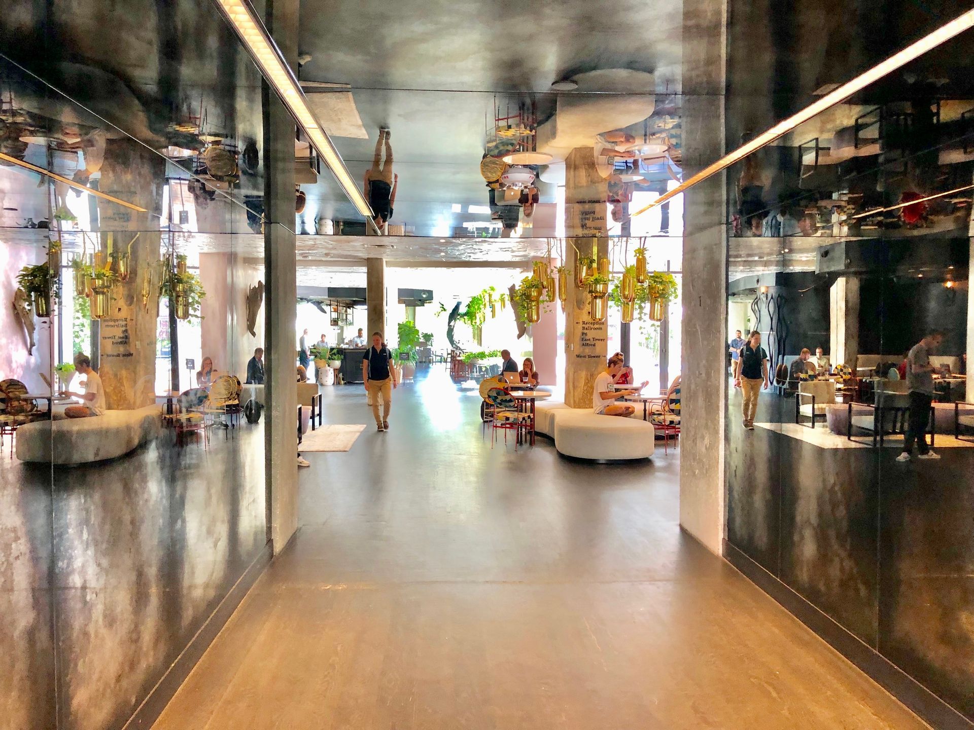 A hallway in a building with people walking down it.