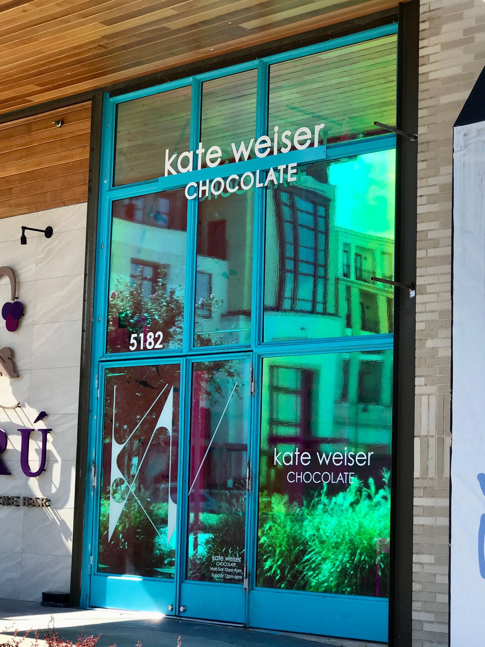 The front door made of dichroic glass at a store called kate weiser chocolate