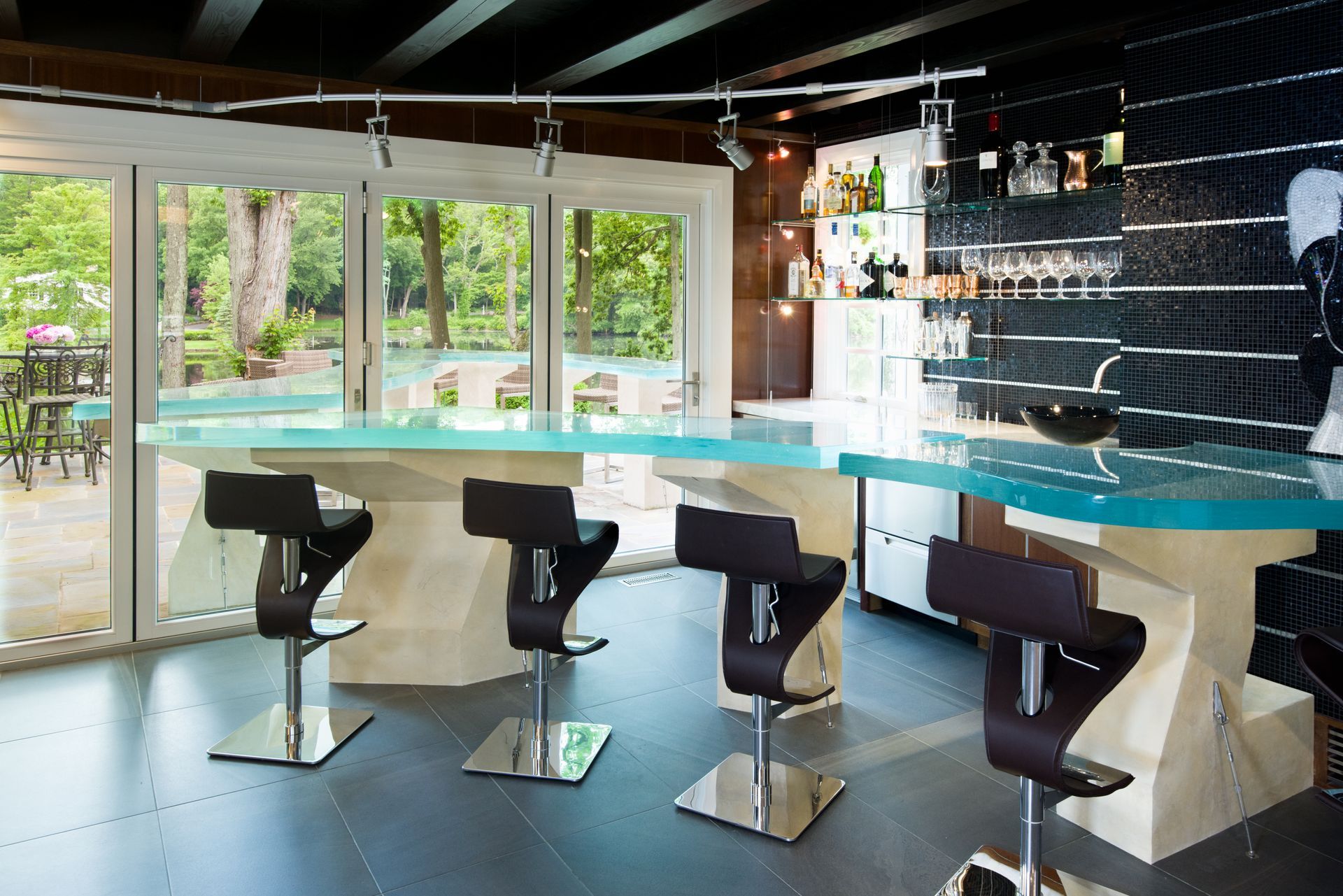 A curved thick glass countertop with texture inside the glass at a private residence.