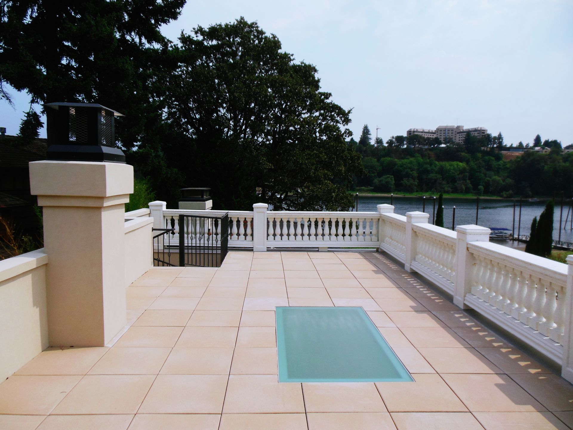 A balcony with a view of a lake and trees
