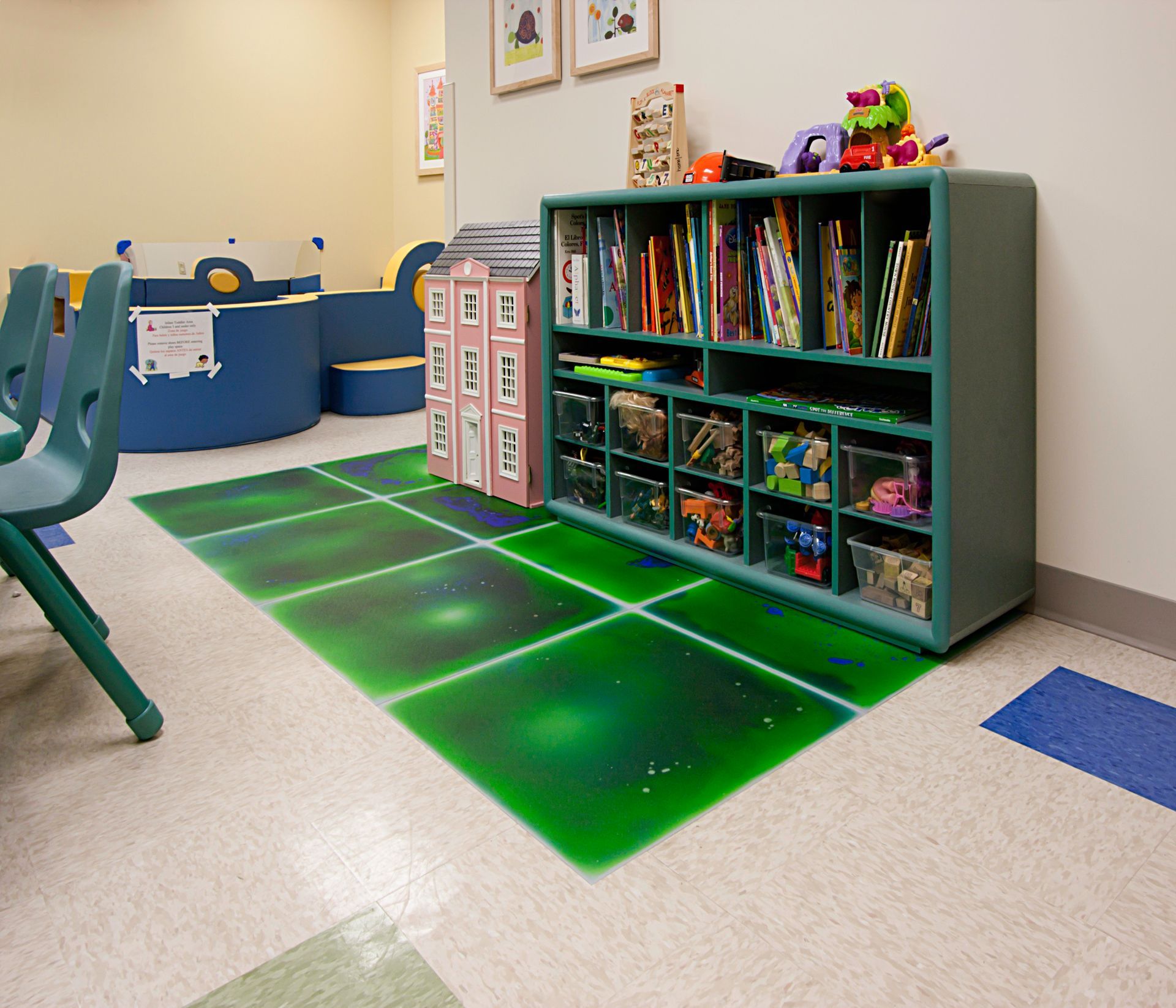 A room with a shelf full of books and toys