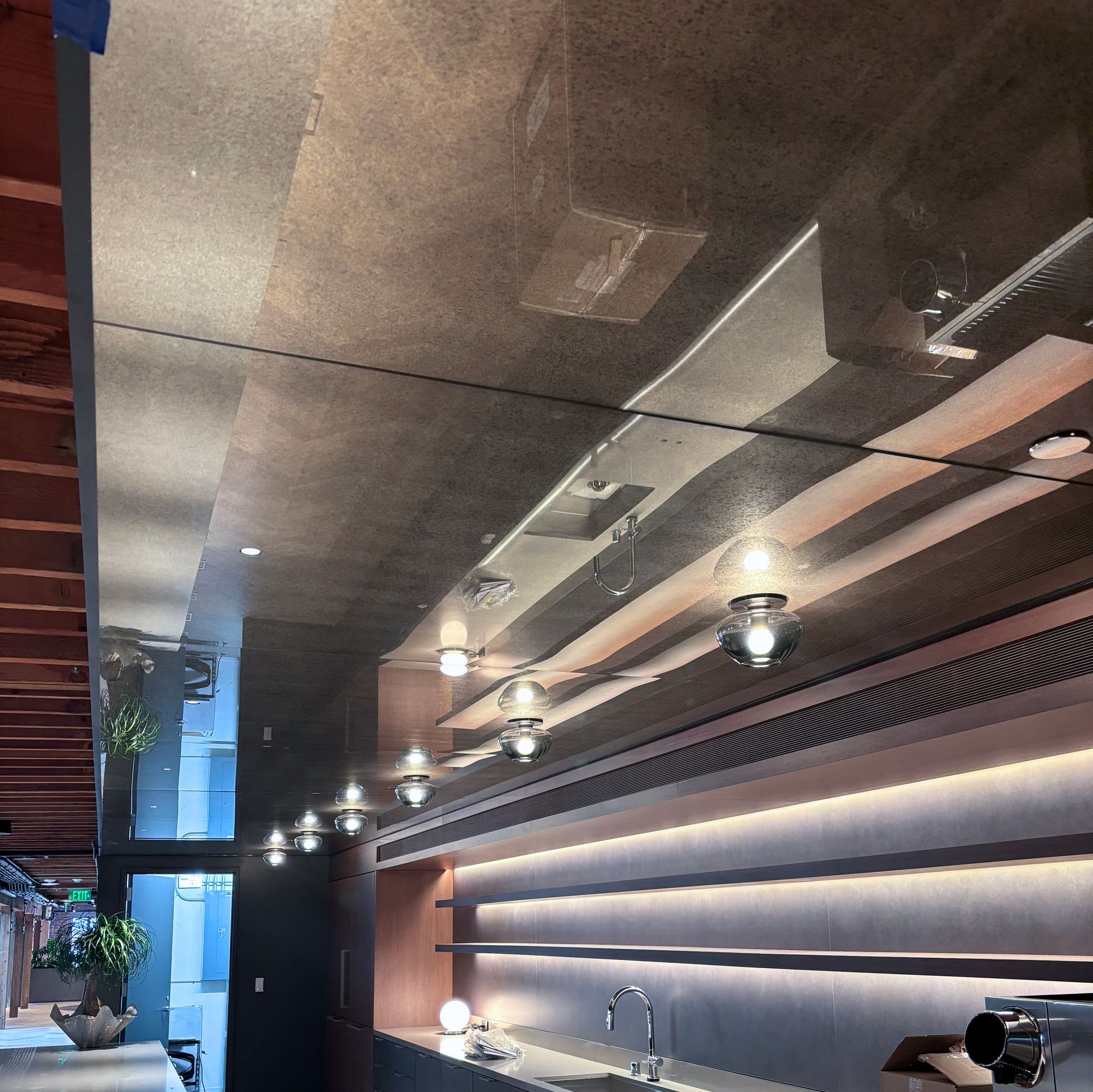 A kitchen with a large mirrored ceiling