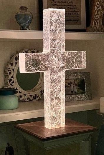 A custom cast glass memorial in the shape of a cross with translucent glass and veining throughout.