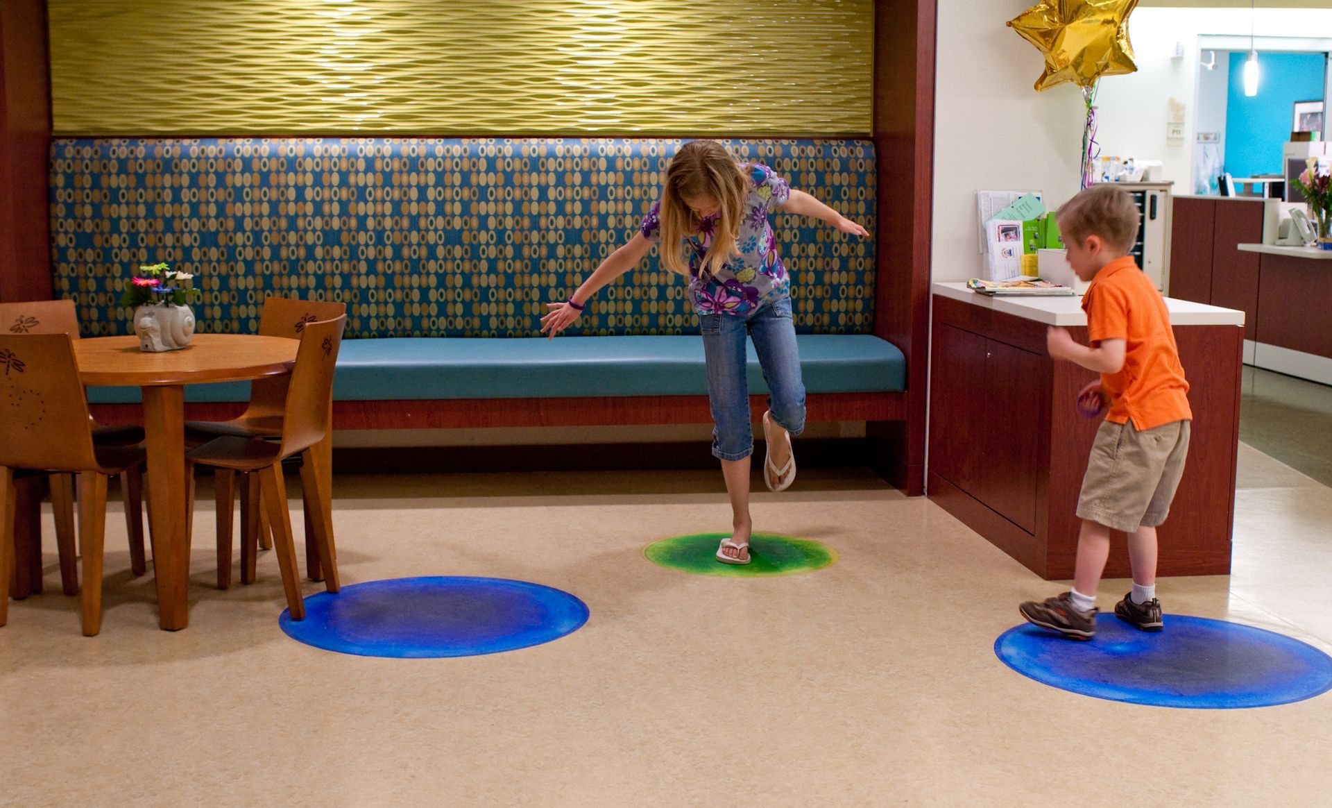 Children jumping on the Liquid Lava tiles in delight.