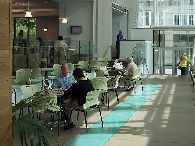 A group of people are sitting at tables in a restaurant