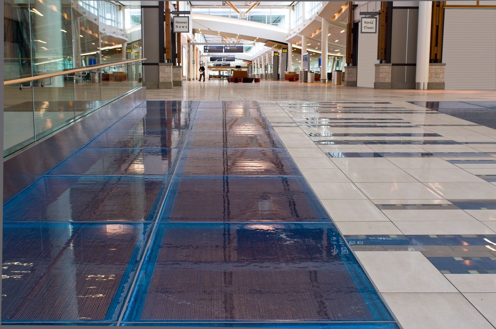 A large hallway with a blue and white tile floor