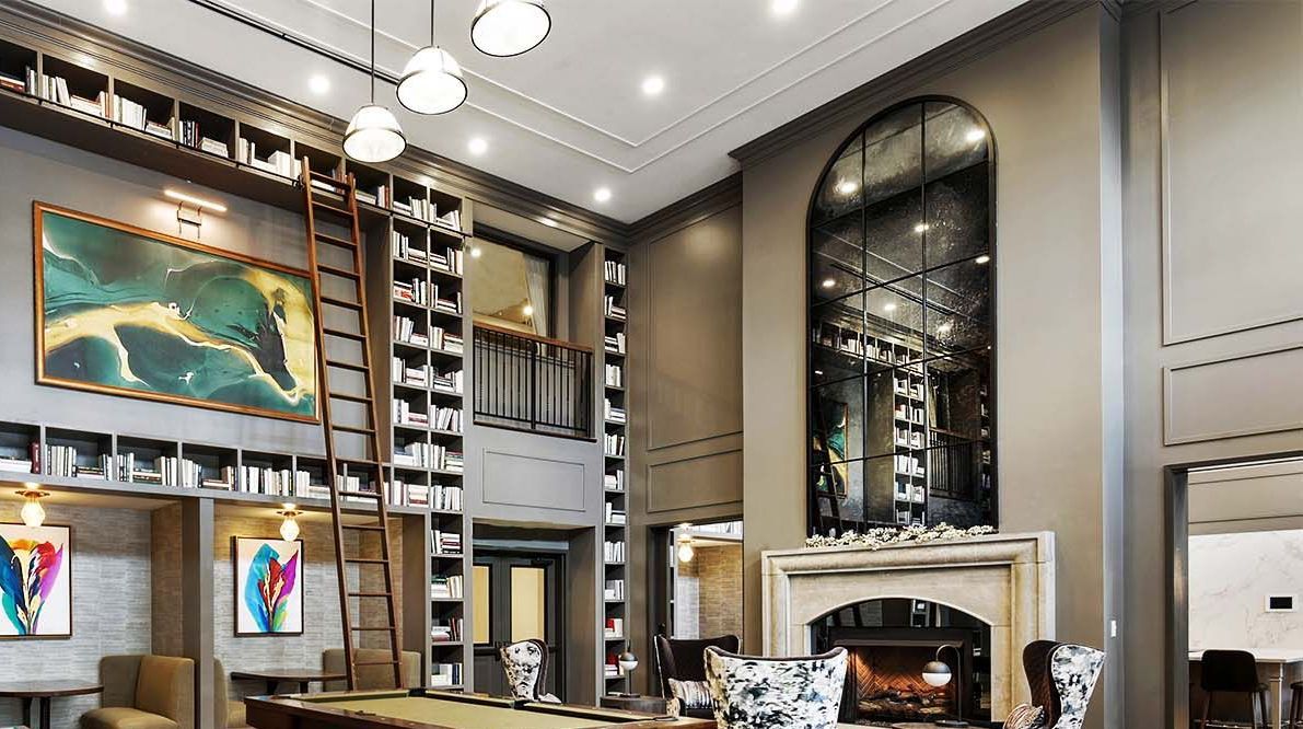 Elegant library with floor-to-ceiling bookshelves, a ladder, fireplace, and art.