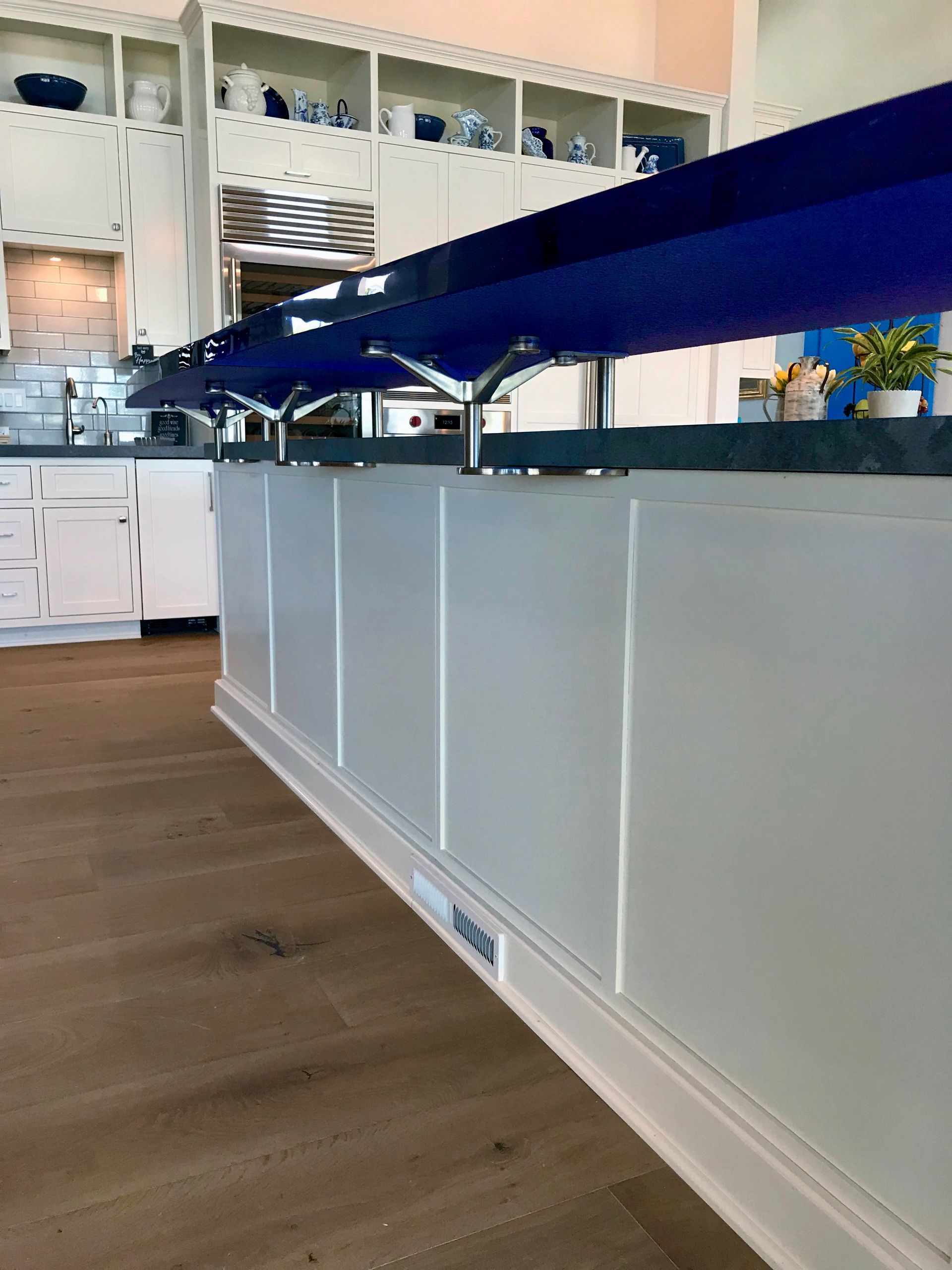 Thick blue glass countertop in a residential kitchen.