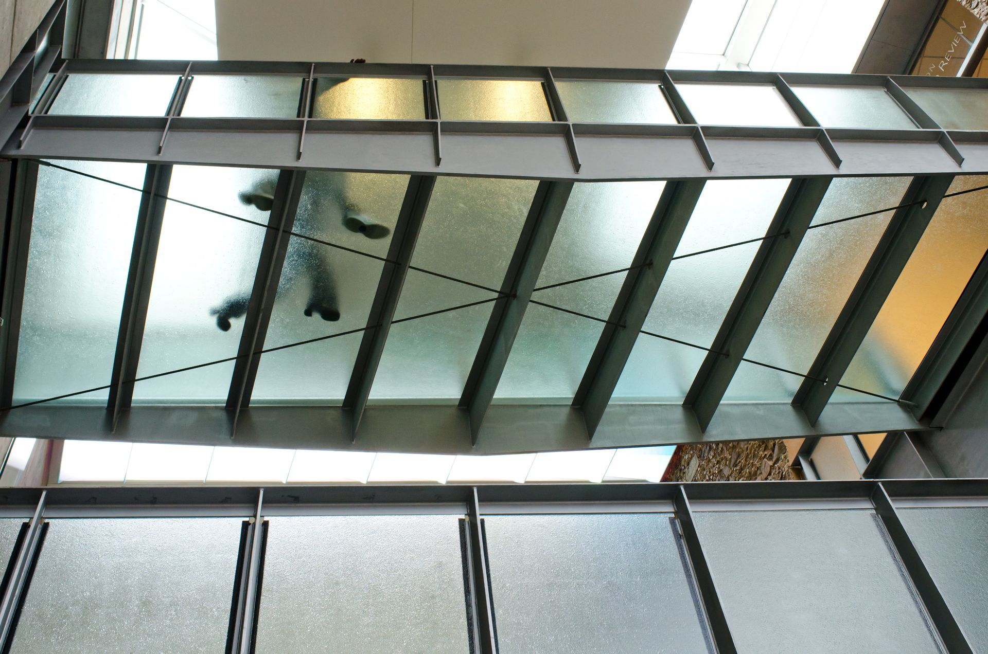 A glass floor looking down onto a car below.