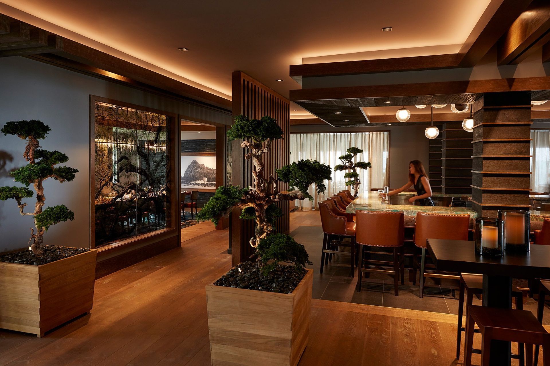 A woman is sitting at a table in a restaurant.