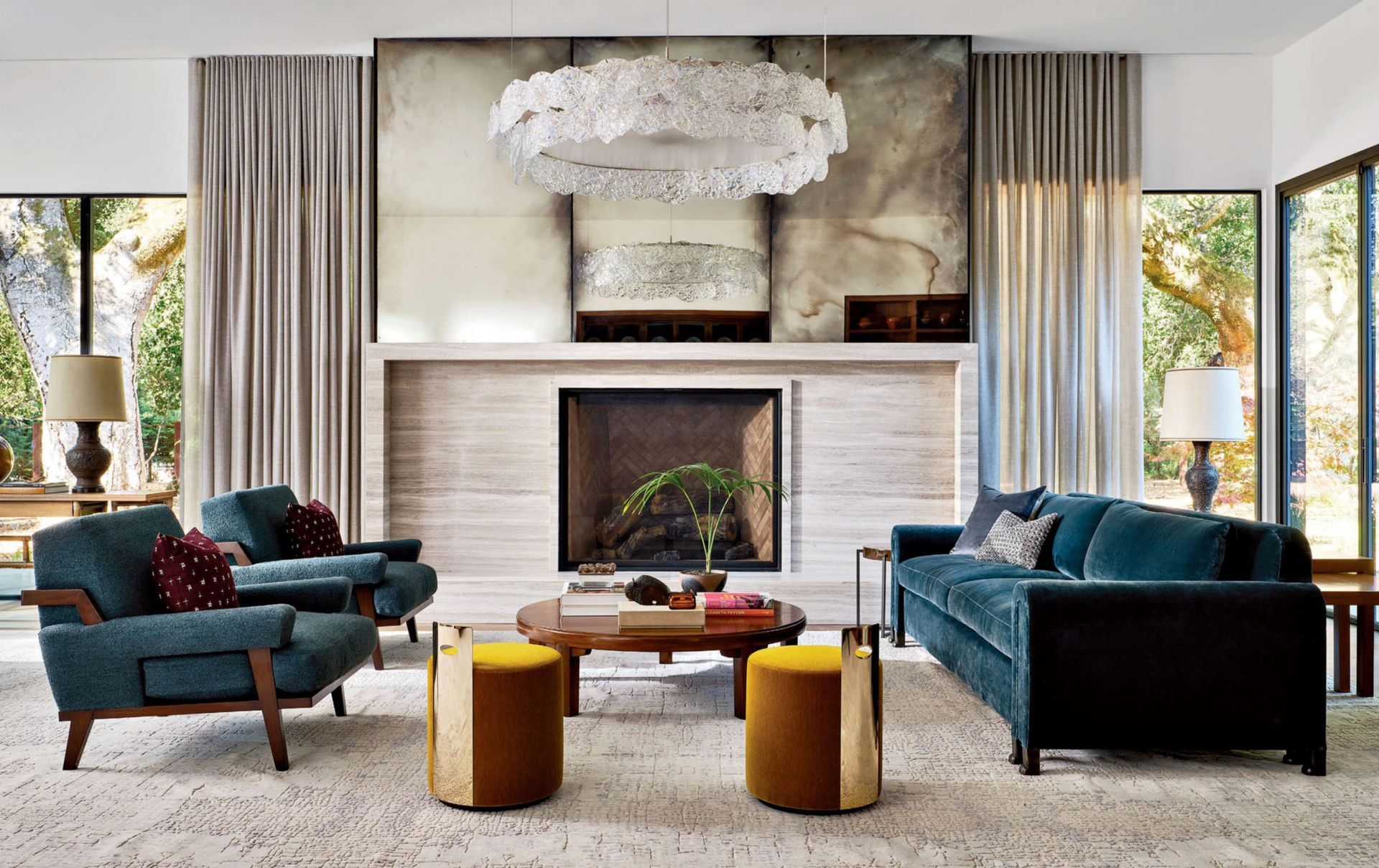 A living room with a couch , chairs , coffee table and fireplace.