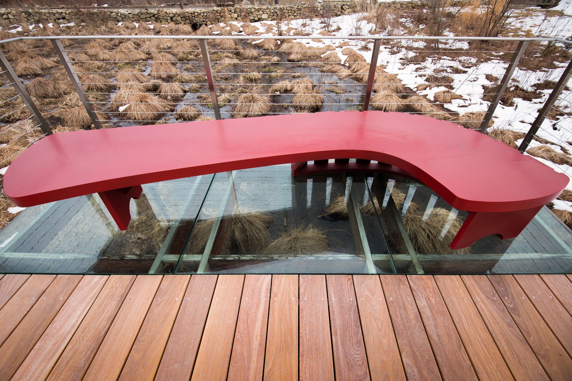 Glass flooring underneath an exterior bench.