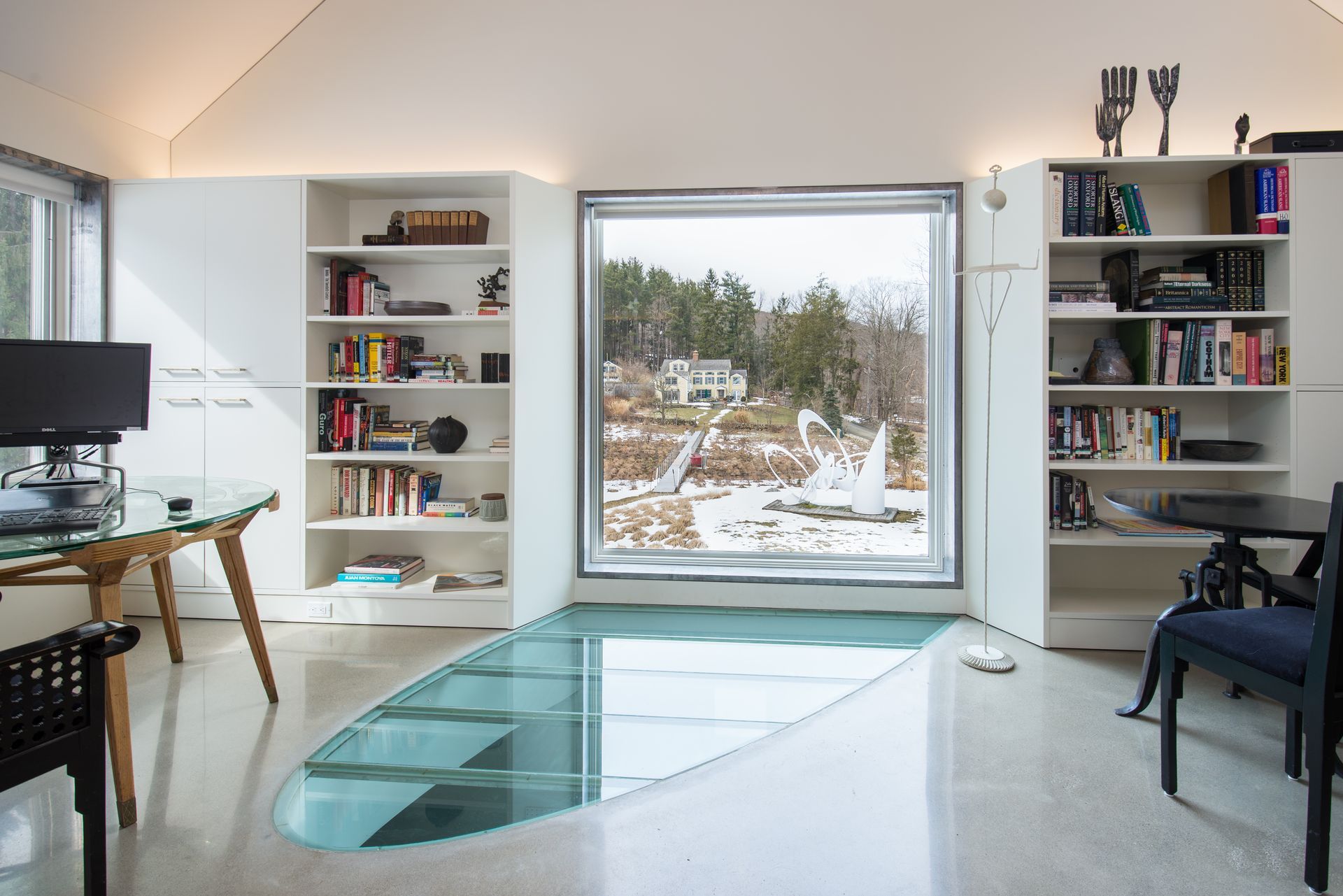 Half an oval of glass flooring in a modern home.