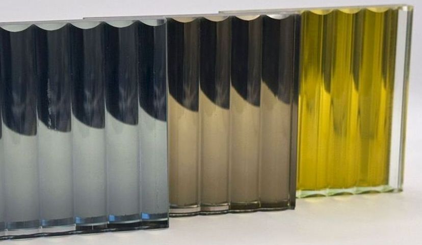Three vertical fluted glass panels in shades of blue-gray, brown-gray, and yellow-green.