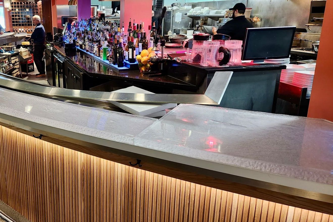 A bar in a restaurant with a lot of alcohol on it.